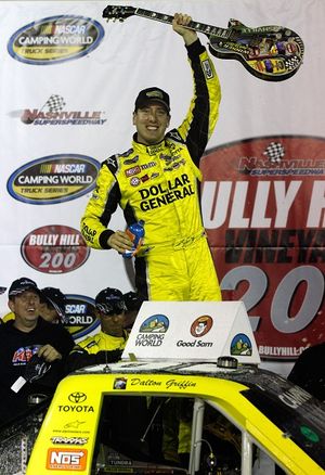 Kyle Busch celebrates after winning both Nashville Superspeedway NASCAR Camping World Truck Series races in which he has started. Busch raises a Gibson guitar Friday in Nashville Superspeedway's Victory Lane. (Photo Credit: Jason Smith/Getty Images for NASCAR) (Jason Smith / Getty Images North America)