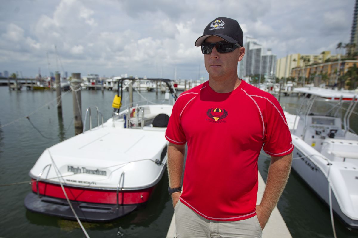 In this Sept. 24, 2012 photo, Dan Breitenstein stands near his boat that he pulls parasailers with over Miami Beach,Fla., discussing the industry. Soaring high above the ocean off South Beach, tethered only by a rope to a boat hundreds of feet below, riding in a parasail is at once exhilarating and oddly peaceful, even quiet. For millions of people, that's the takeaway from a once-in-a-lifetime experience. But every year there are accidents, some of them fatal. The Parasail Safety Council, which tracks injuries and deaths from the activity nationwide, reports more than 70 people have been killed and at least 1,600 injured between 1982 and 2012, out of an estimated 150 million parasail rides during those 30 years. Despite the inherent risk, few federal or state safety regulations exist for parasailing. In Florida, which has by far the largest number of parasail operators at about 120, repeated efforts to enact new rules following fatal accidents have landed with a thud. Florida is seen by safety proponents as a national bellwether because of parasailing's popularity in the state. (J Carter / Associated Press)