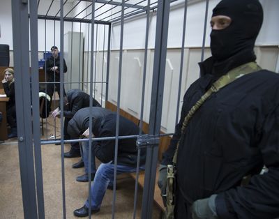 From left: Tamerlan Eskerkhanov, Shagid Gubashev and Khamzad Bakhaev are suspected of involvement in the killing of Boris Nemtsov on Feb. 27. (Associated Press)