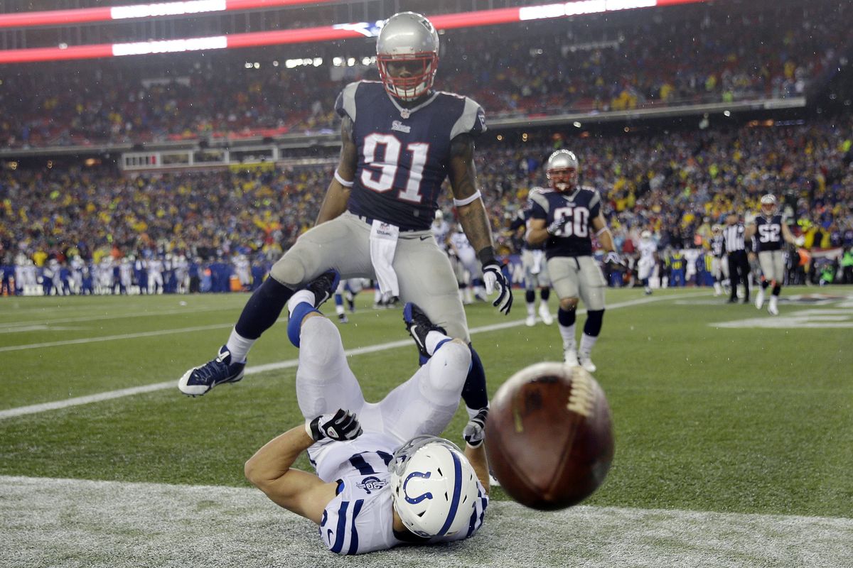 A pass gets away from Colts tight end Coby Fleener under pressure from Patriots’ linebacker Jamie Collins, top. (Associated Press)