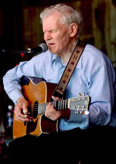 In this 2005 photo, master flatpicker Doc Watson plays at MerleFest in Wilkesboro, N.C. (Associated Press)