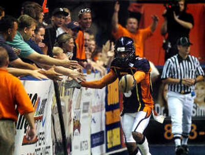 
The Shock's Nygel Rogers reacts with fans in the endzone after scoring a touchdown against the Tri-Cities Fever.
 (Ingrid Barrentine / The Spokesman-Review)
