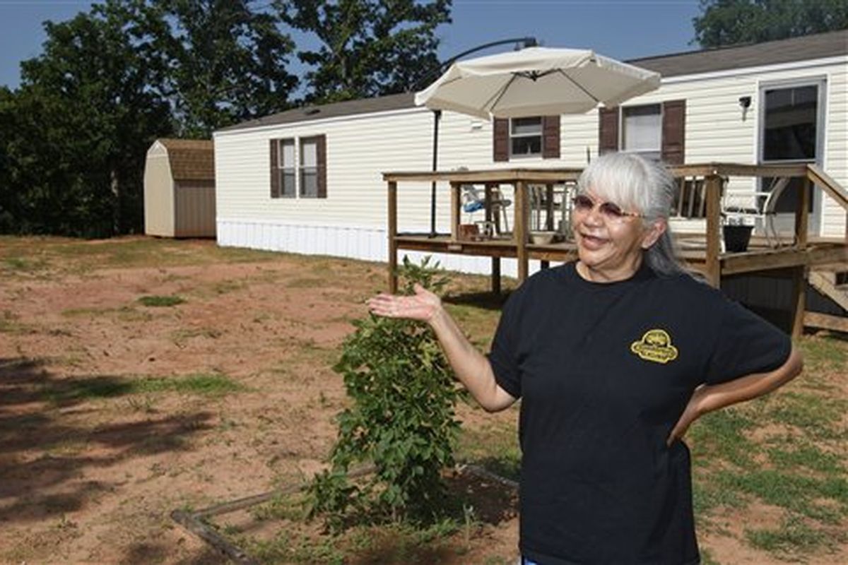 Wanda Tiger talks outside her FEMA trailer home in Little Axe, Okla., on June 16. Nearly six years after Hurricane Katrina, the mobile homes that became a symbol of the government