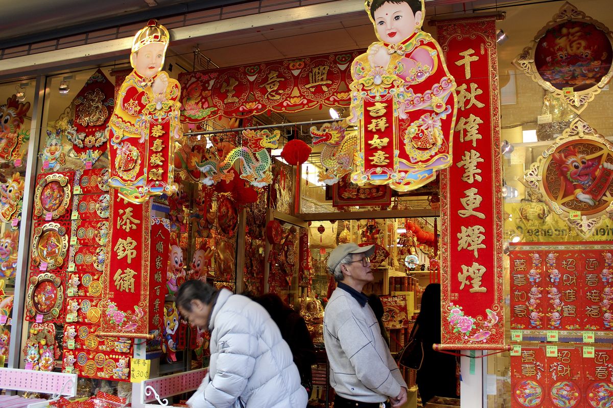 Shoppers look at Lunar New Year decorations in Chinatown in San Francisco. Red and gold are the dominant colors of Chinese New Year decorations, with gold signaling prosperity and red indicating life. (Associated Press)