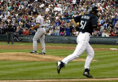 
New York Mets starter Kazuhisa Ishii looks away as Ichiro Suzuki of Seattle trots from third base to home after hitting a three-run homer in the second inning. 
 (Associated Press / The Spokesman-Review)