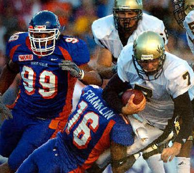 
Idaho, with quarterback Michael Harrington sacked here in last year's loss to Boise State, hopes to be more competitive this year against the Broncos. 
 (File/ / The Spokesman-Review)