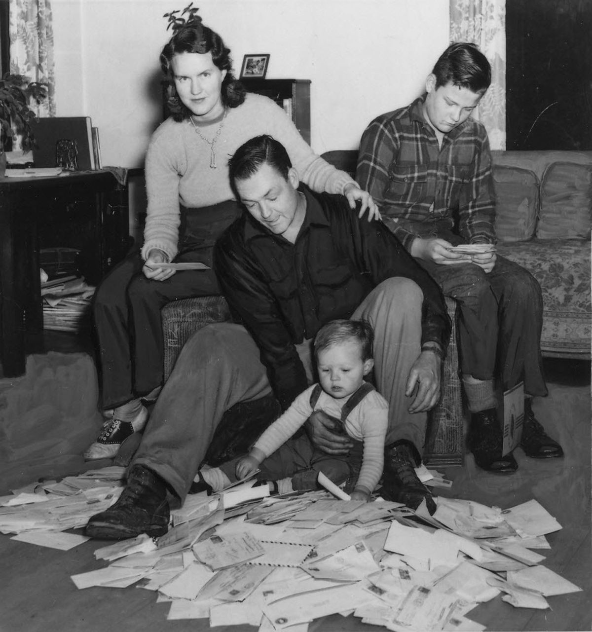 This 1946 newspaper photograph shows Clarence Dirks, wife Cleo, sons Marty and "Baby Mike" enjoying thousands of fan-mail letters from all over the country, from readers of Dirks