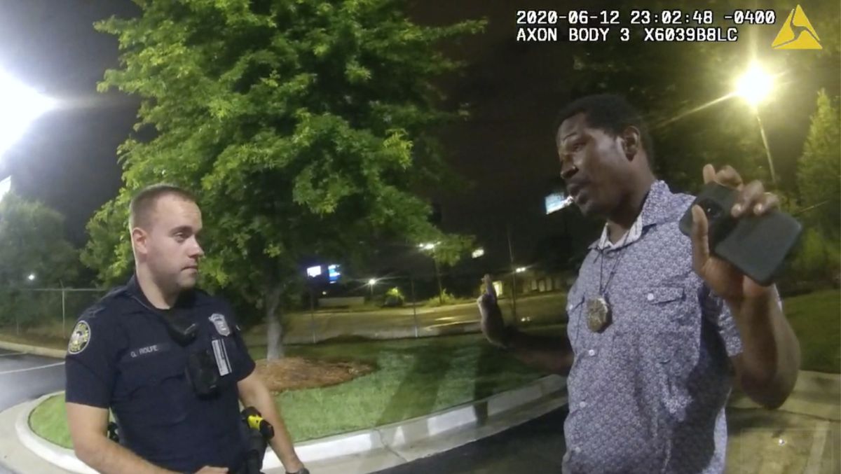 FILE - This screen grab taken from body camera video provided by the Atlanta Police Department shows Rayshard Brooks speaking with Officer Garrett Rolfe, left, in the parking lot of a Wendy