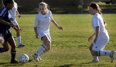
Sisters Bryana, right, and Morgan Manchester, center, play defense for East Valley High School during a soccer game against Mt. Spokane  Tuesday. The Knights lost the game and will be the No. 2 GSL seed into the Class 3A district tournament.  
 (Holly Pickett / The Spokesman-Review)