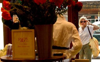 
A curious onlooker peers into the front window of the Coldwater Creek store in Sandpoint.  
 (File/ / The Spokesman-Review)