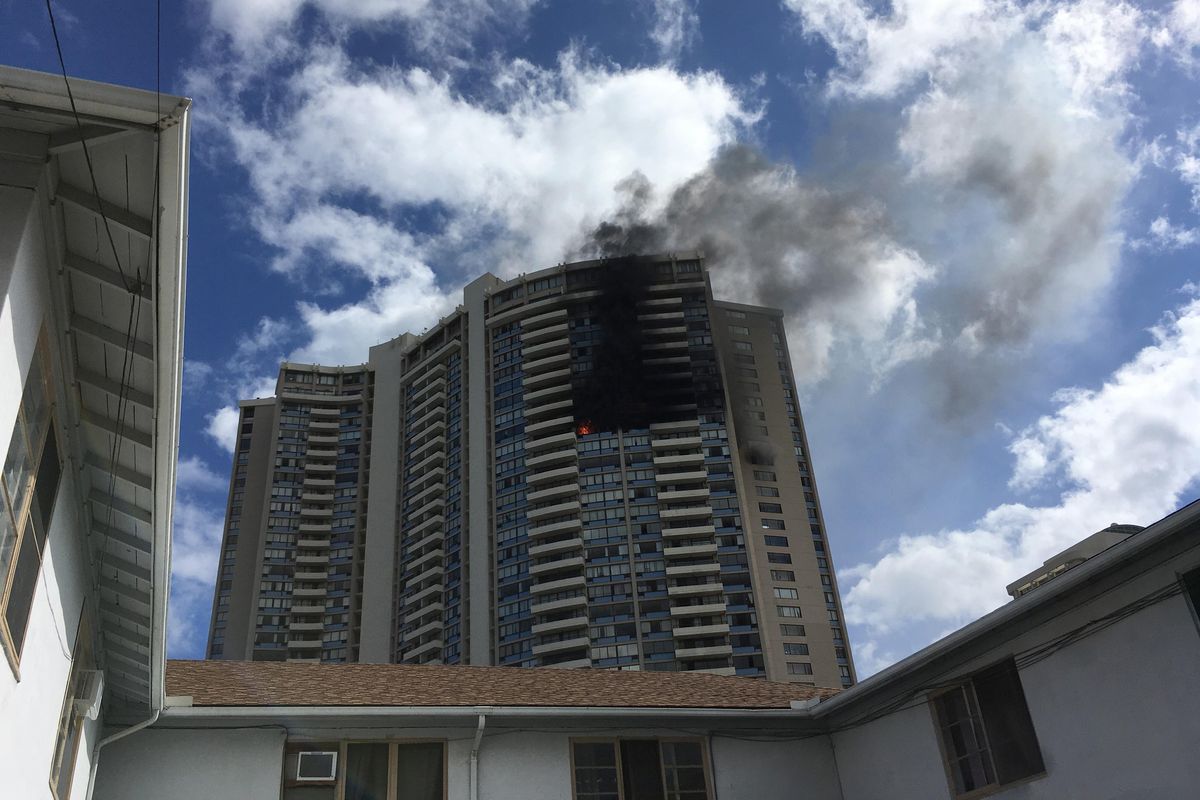 Smoke billows from a high-rise apartment building in Honolulu, Friday, July 14, 2017. Dozens of firefighters are battling the multiple-alarm fire at Marco Polo apartments that Honolulu Fire Department spokesman Capt. David Jenkins said started on the 26th floor and has spread to other units. (Audrey McAvoy / Associated Press)