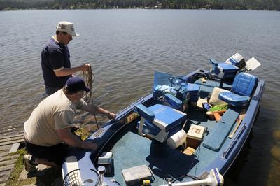 Vince Wilson, below, and his brother Brian Wilson, of Spokane, prepare their father’s boat for launch Friday at Newman Lake. Spokane and Kootenai county deputies will be working overtime over Memorial Day weekend to enforce boater-safety laws, including a few new ones.  (Jesse Tinsley / The Spokesman-Review)