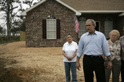 
President Bush talks to reporters in front of the rebuilt home of the Woodward family in Long Beach, Miss., on Thursday. 
 (Associated Press / The Spokesman-Review)