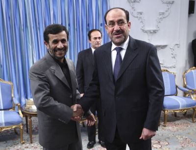 Iranian President Mahmoud Ahmadinejad, left, greets  Iraqi Prime Minister Nouri al-Maliki in Tehran, Iran, on Saturday.  (Associated Press / The Spokesman-Review)