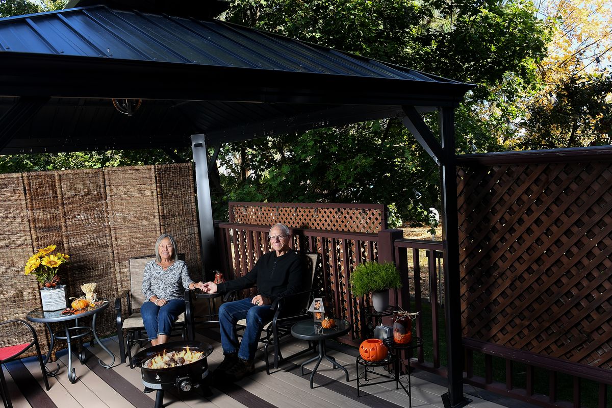 Jim and Marie Magers are photographed on their newly refurbished deck and gazebo on Oct. 15 at their home in Spokane. When the Magers decided to redo their deck and gazebo, they found a stone memento that showed them how long it had been since they first built it.  (Tyler Tjomsland/THE SPOKESMAN-REVIEW)