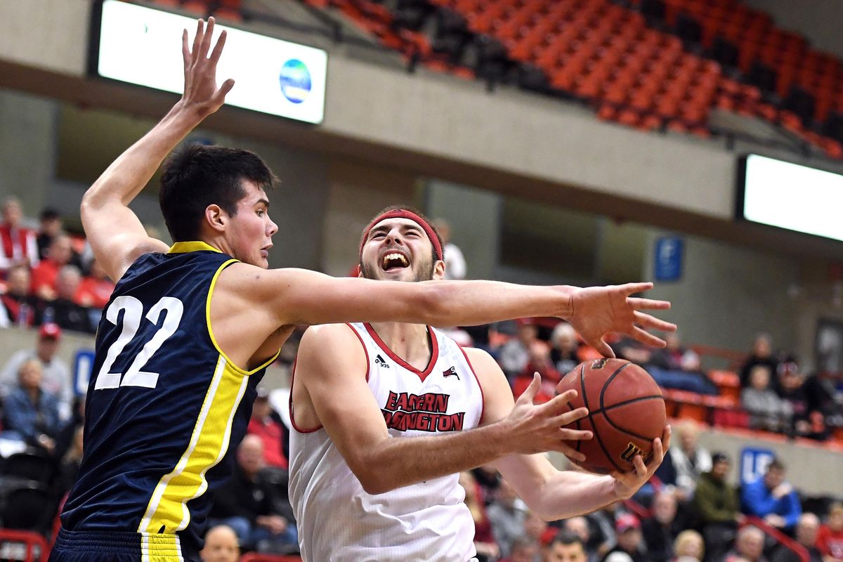 Eastern Washington forward Jesse Hunt (34) is fouled by Northern Arizona forward Brooks DeBisschop (22) during the second half of a college basketball game, Mon., Feb. 4, 2019, on Reese Court at Eastern Washington University. (Colin Mulvany / The Spokesman-Review)