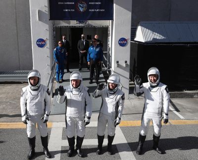Left to right, Crew-11 members Roscosmos cosmonaut Oleg Platonov; NASA astronauts Zena Cardman and Michael Fincke; and JAXA astronaut Kimiya Yui, walk out on July 31 on their way to their launch from Kennedy Space Center Launch Complex 39A.  (Ricardo Ramirez Buxeda/Orlando Sentinel/TNS)
