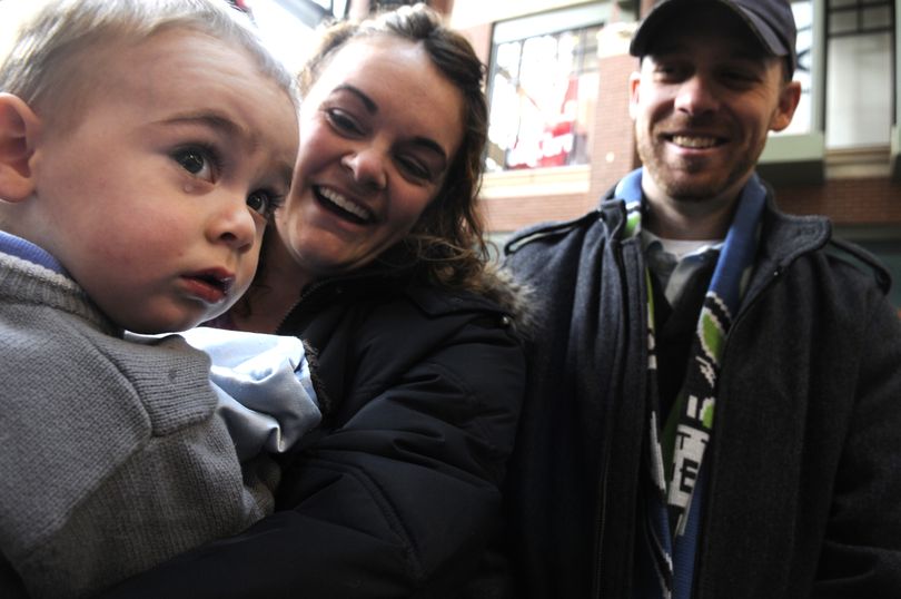 Jack Hughes, 18-months-old, is rescued from Santa's lap at Riverpark Square Thursday, Dec. 24, 2009 by his mother Elizabeth, center, and father Liam, right.  Elizabeth admits to being afraid of Santa and crying when she was a child. (Jesse Tinsley / The Spokesman-Review)