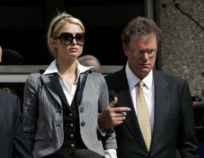 
Paris Hilton leaves a Los Angeles courthouse Friday with her father, Rick, after  a judge sentenced her to 45 days in jail for violating her probation. Hilton must begin serving her sentence by June 5.
 (Associated Press / The Spokesman-Review)