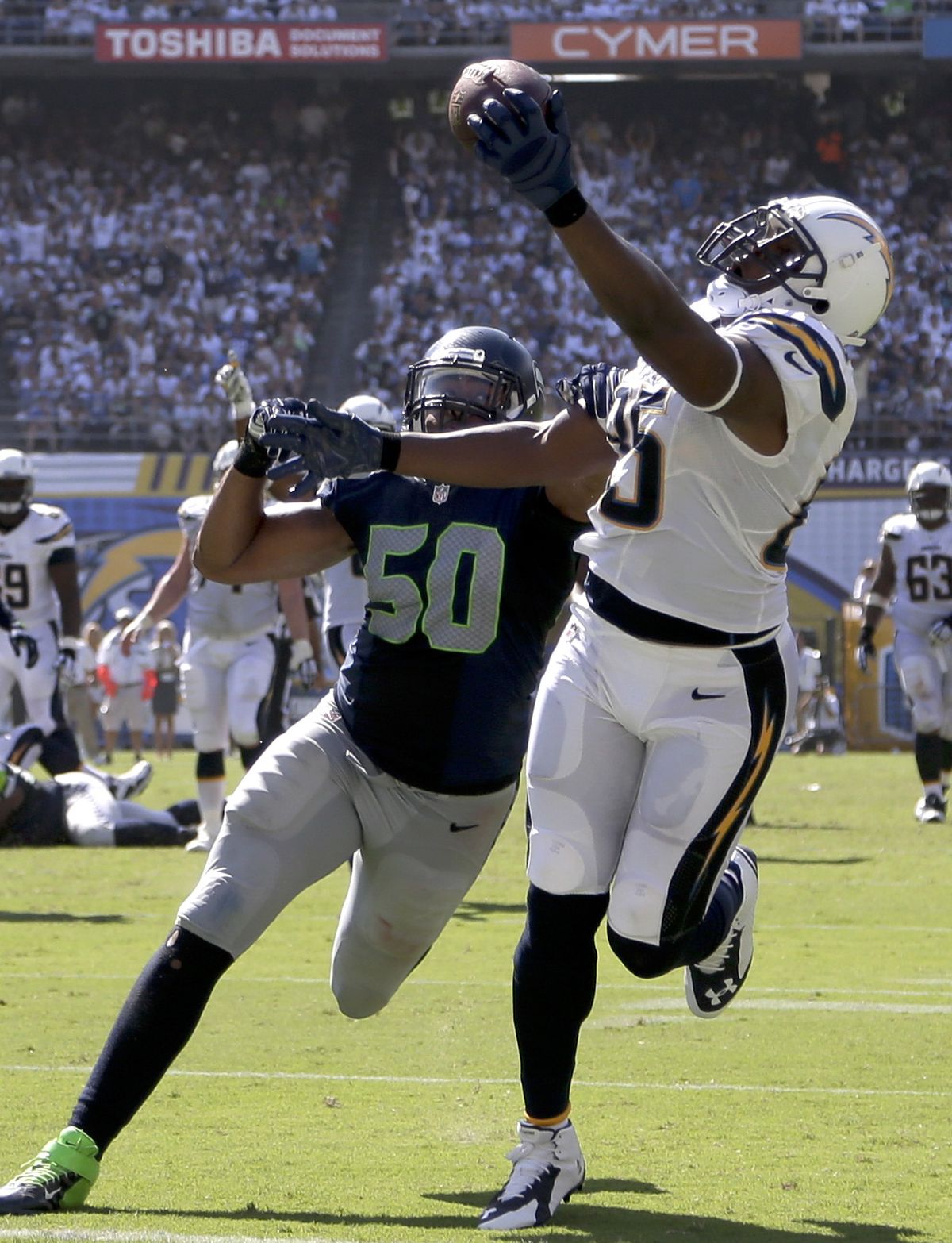 The Chargers’ Antonio Gates scores against Seahawks outside linebacker K.J. Wright, one of three TD catches for the tight end. (Associated Press)