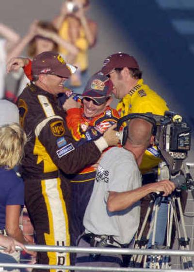 
Dale Jarrett, left and Elliott Sadler, right, joke with and congratulate Jeff Gordon near the winner's podium. 
 (Associated Press / The Spokesman-Review)