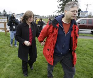 Ken and Cindy Paulson the father and step-mother of slain teacher Jennifer Paulson, walk away after talking to reporters Friday, Feb. 26, 2010 outside Birney Elementary School in Tacoma, Wash. where their daughter was fatally shot earlier in the morning. Authorities say the suspect in the shooting was later killed in a shootout with a Pierce County Sheriff's deputy. (Ted Warren / Associated Press)