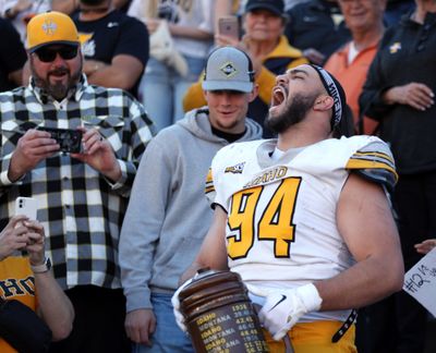 Nate DeGraw celebrates with the Little Brown Stein after Idaho defeated third-ranked Montana 30-23 Saturday in Missoula.  (Courtesy of Idaho Athletics)