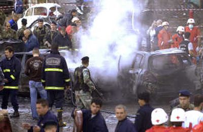 
Soldiers and emergency personnel work  early Wednesday after a bomb exploded in a Christian suburb of Beirut, Lebanon. Associated Press
 (Associated Press / The Spokesman-Review)