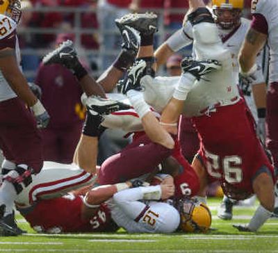 
Three WSU defensive linemen team up to go upside down and sack Arizona State quarterback Rudy Carpenter, one of seven sacks on the day. 
 (Christopher Anderson / The Spokesman-Review)