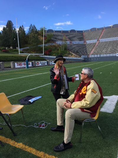 Jerri Sher, director and producer of the documentary “Quiet Explosions: Healing the Brain,” talks at Joe Albi Stadium with Mark Rypien, Super Bowl XXVI MVP, who is among the people featured in the film because of traumatic brain injury. (Courtesy)