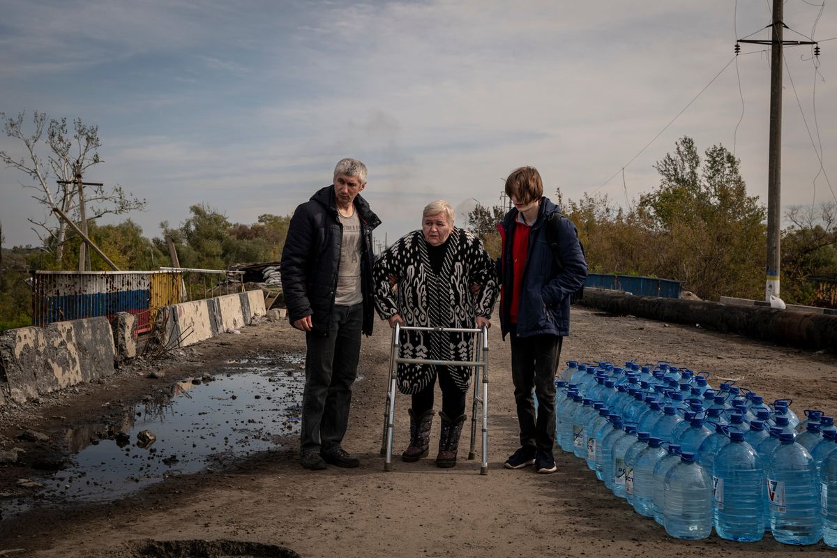 Civilians make their way across a destroyed bridge in Kupiansk, Ukraine on Friday, Sept. 30, 2022. The Ukrainian military has pushed Russian forces further southeast of the Oskil River as they continue their counter-offensive in the Kharkiv region. (Nicole Tung/The New York Times)  (NICOLE TUNG)