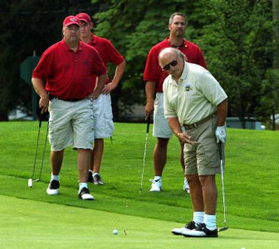 
Actor Dennis Franz, far right, watches his ball roll toward the cup on the first green while his golfing partners, from left, Cliff Berdar, Josh Begovich and Troy Clute watch his progress at the Kootenai County Police and Fire Memorial Foundation golf tournament Friday.
 (Jesse Tinsley / The Spokesman-Review)