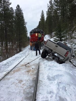 A train moves in to pull a stuck truck off the railway in Ferry County. (Washington Department of Fish and Wildlife)