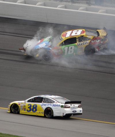 David Gilliland (38) avoids Kyle Busch’s wrecked car during last Sunday’s Sprint Cup race at Kansas Speedway. (Associated Press)