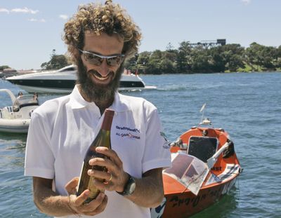 Italian adventurer Alex Bellini receives a bottle of wine as he arrives at the Opera House today in Sydney, Australia.  (Associated Press / The Spokesman-Review)