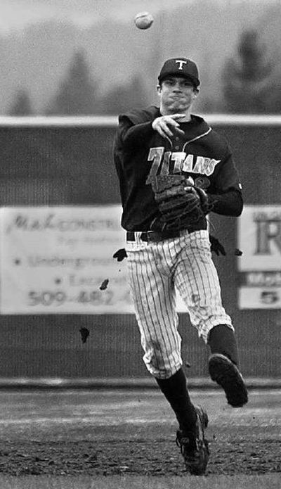 University shortstop Jacob Olsufka makes a toss to first during game on a rainy Wednesday afternoon.
(Jed Conklin / The Spokesman-Review)