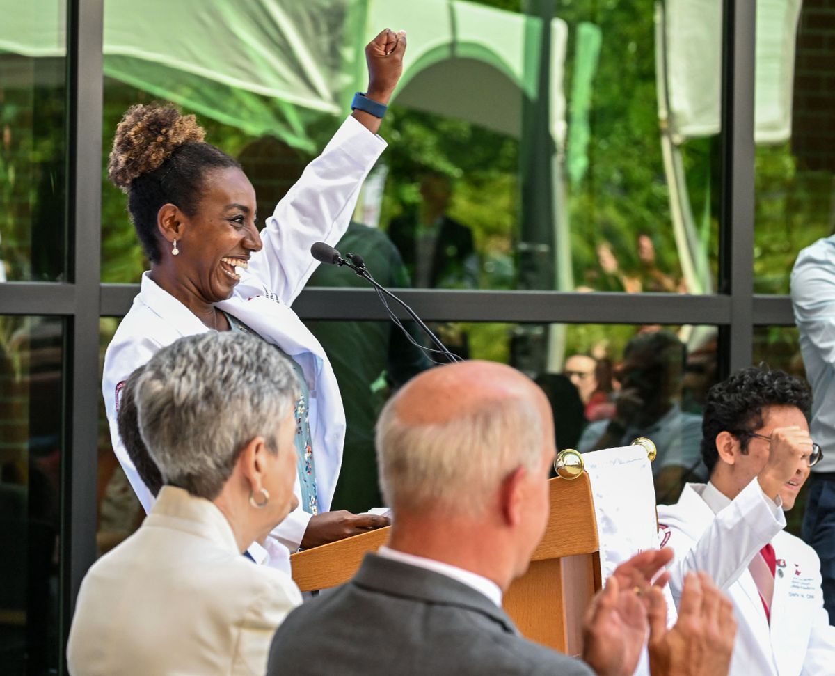 Third-year medical student Lensa Moen leads a gathering of people in a “Go Cougs” shout during the opening of the Washington State University Medicine Building on Thursday in Spokane.  (DAN PELLE/THE SPOKESMAN-REVIEW)