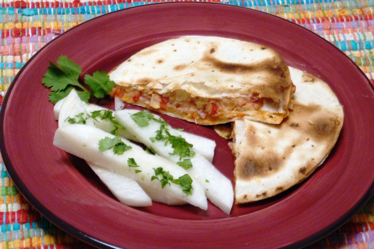 These quesadillas use flour tortillas filled with a savory bean mixture, melted Monterey Jack cheese and ham, with jicama on the side.