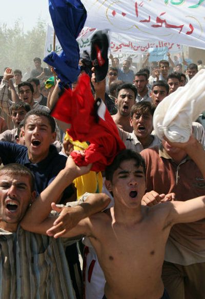 
Protesters rally in Ramadi, a Sunni city west of Baghdad, Friday. Several hundred people demonstrated against the constitution.
 (Associated Press / The Spokesman-Review)