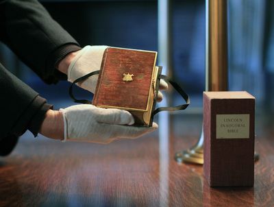 Curator Clark Evans displays the burgundy velvet, gilt-edged Lincoln inaugural Bible at the Library of Congress on Tuesday.  (Associated Press / The Spokesman-Review)