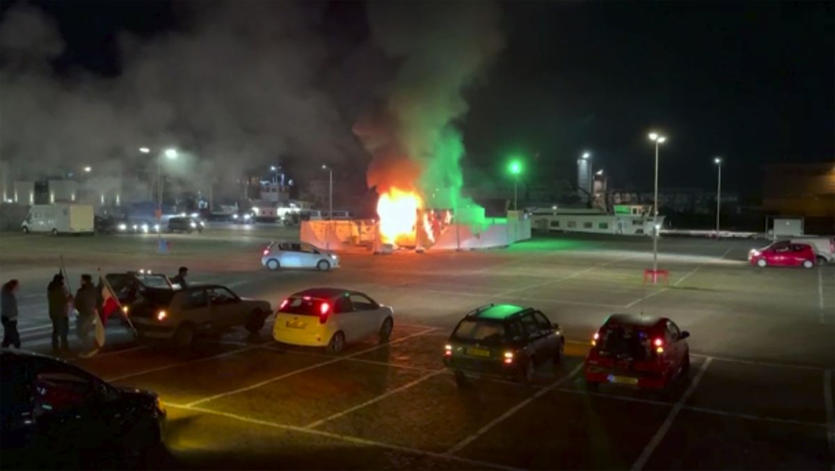 In this image made from video, a COVID-19 testing center is seen after being set on fire in Urk, 80 kilometers (50 miles) northeast of Amsterdam, Saturday, Jan. 23, 2021. Dutch police have clashed with protesters demonstrating against the country’s lockdown in the capital, Amsterdam and the southern city of Eindhoven. The unrest comes a day after rioting youths protesting on the first night of the country’s curfew torched a coronavirus testing facility in Dutch fishing village Urk.  (HONS)