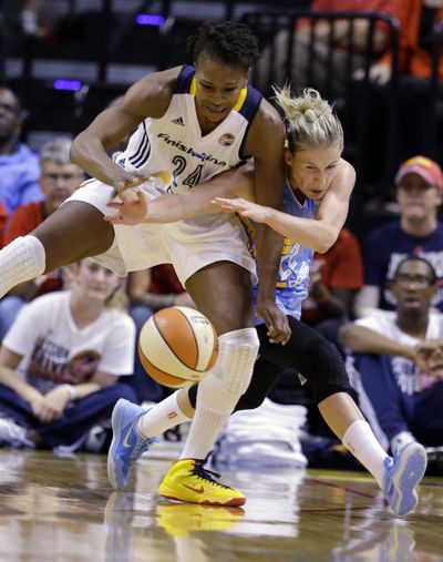 Indiana Fever forward Tamika Catchings, left, and Chicago Sky guard Courtney Vandersloot get tied up as they go for a loose ball. (Associated Press)