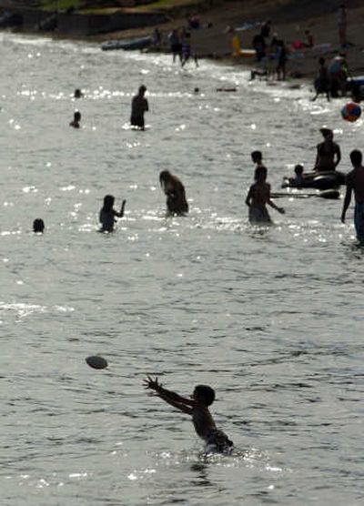 Beachgoers splash in Lake Coeur d'Alene last summer. The Spokesman-review
(File The Spokesman-review / The Spokesman-Review)