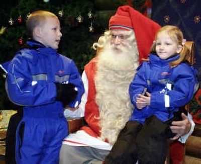 
Santa talks with children in the Santa's village on the Artic circle last week in Rovaniemi, Finland. 
 (Associated Press / The Spokesman-Review)