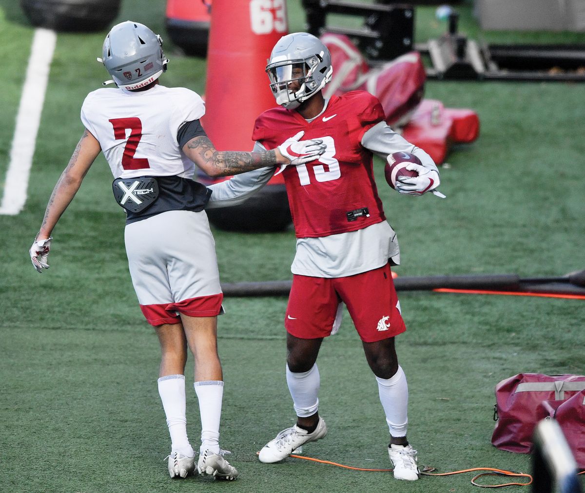 WSU defensive back Derrick Langford (2) congratulates WSU receiver Donovan Ollie (13) after Ollie caught a long pass during a spring college football practice on Thursday, April 8, 2021, on WSU's practice field in Pullman, Wash.    (Tyler Tjomsland / The Spokesman-Review)