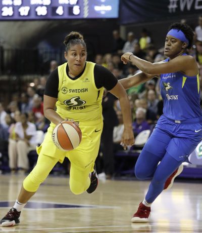 Seattle Storm’s Kaleena Mosqueda-Lewis, left, drives past Dallas Wings’ Kaela Davis during the second half of a WNBA basketball game Friday, July 12, 2019, in Seattle. Mosqueda-Lewis led the Storm with 18 points in their 95-81 victory. (Elaine Thompson / Associated Press)