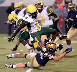 Shadle Park's Alvin Welch (5) trips over Mead's A.J. Layton in the first half Friday, Oct. 10, 2013 at Joe Albi Stadium. (Jesse Tinsley / The Spokesman-Review)