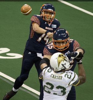 Shock QB Brian Zbydniewski throws over lineman Patrick Afif and San Jose’s Terrance Carter (23). (Dan Pelle)