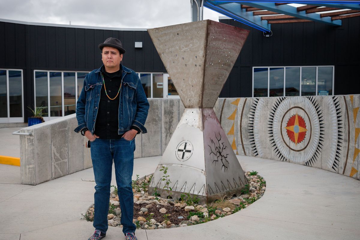 Marty Two Bulls Jr., an artist laureate of the Oglala Sioux Nation, with the sculpture he designed with other artists in the sculpture garden at the Oglala Lakota Artspace in Kyle, S.D., on Oct. 14. A Native-run studio, the Artspace is a beacon of hope, nurturing talent amid a resurgence of Indigenous traditions.  (TARA WESTON/New York Times)