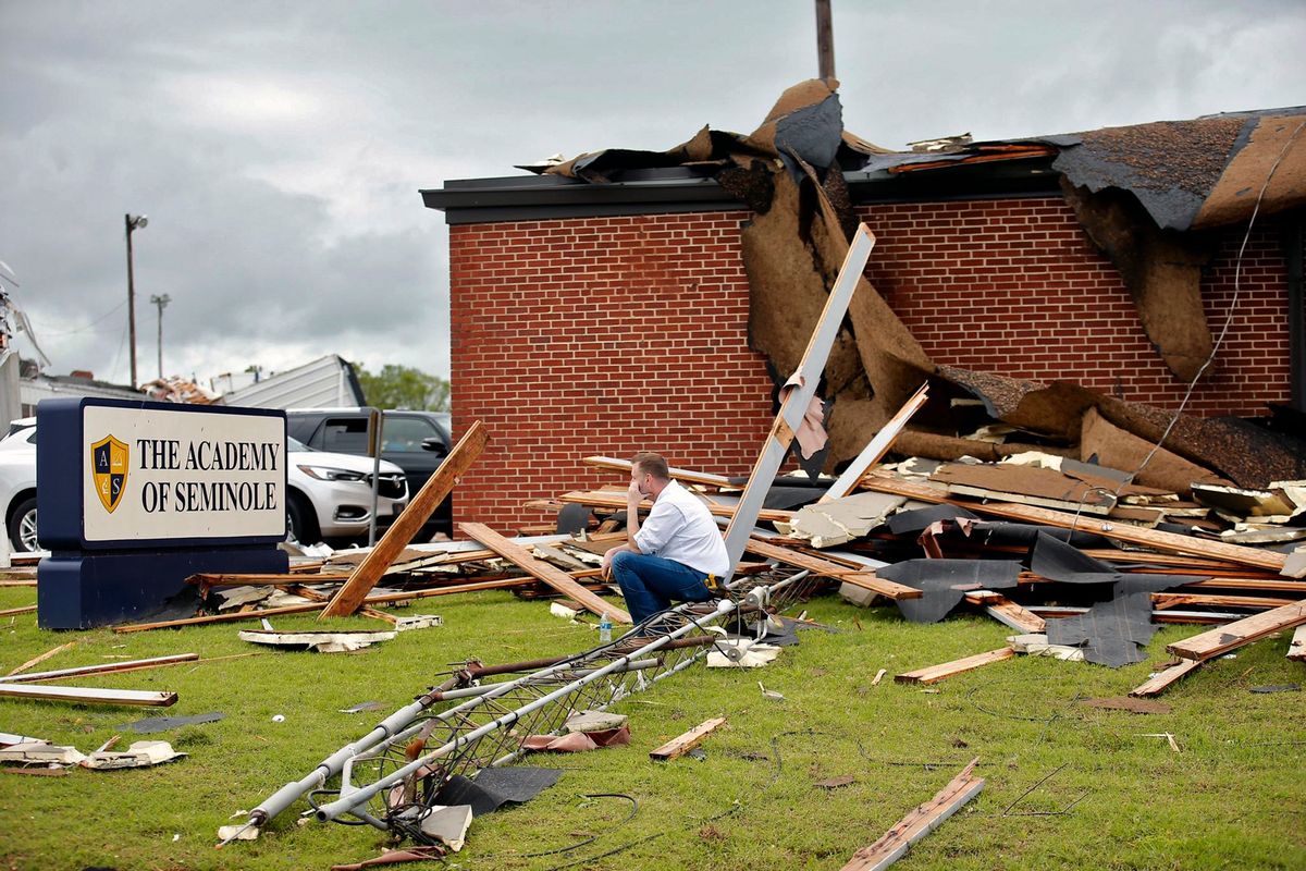 Surrounded by tornado damage Paul Campbell, founder of the Academy of Seminole, sits outside of the school in Seminole, Okla., on Thursday.  (Sarah Phipps)
